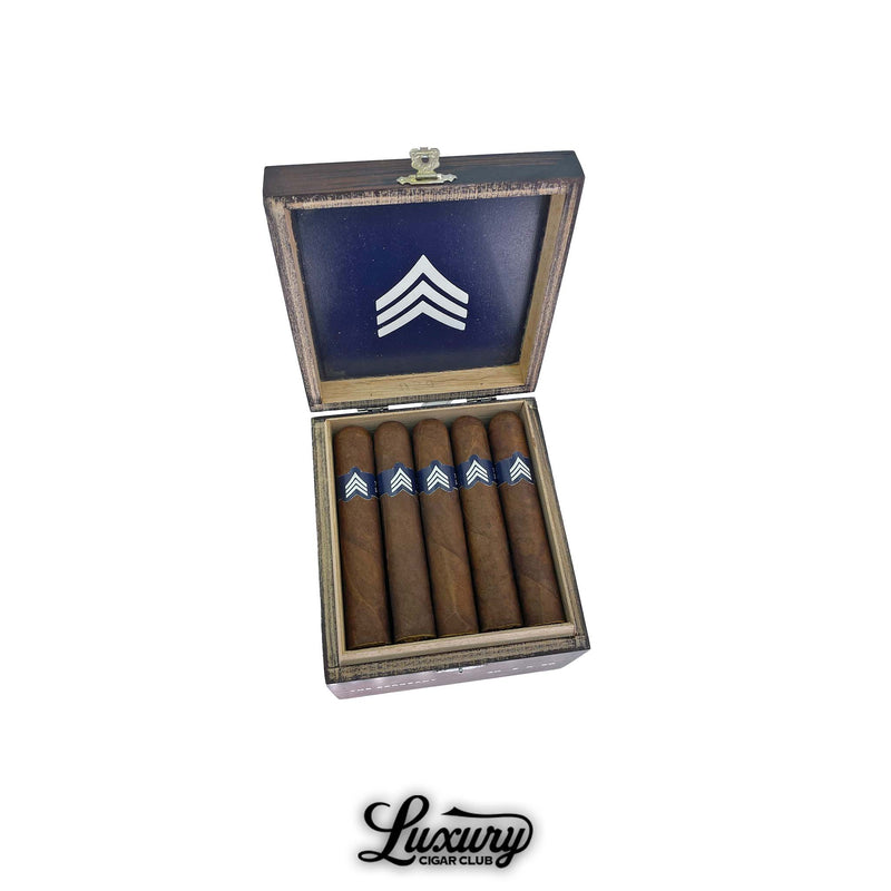 Luciano The Sergeant Robusto Gordo cigars displayed in an open rustic wooden box with blue and white chevron logo, featured by Luxury Cigar Club.