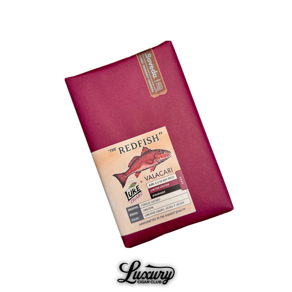Red paper-wrapped bundle of Toro cigars featuring “The Redfish” label with illustrated redfish, details of Corojo Oscuro wrapper, Ometepe binder, and fillers from Ometepe Ligero, Estelí, and Jalapa, humidity control pack visible, displayed with Luxury Cigar Club branding.