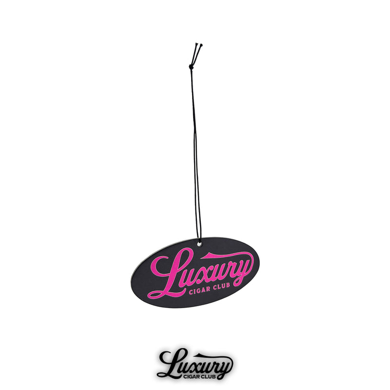 Black oval Luxury Cigar Club sandalwood air freshener with pink logo lettering, shown with attached black string for hanging in cars or rooms.