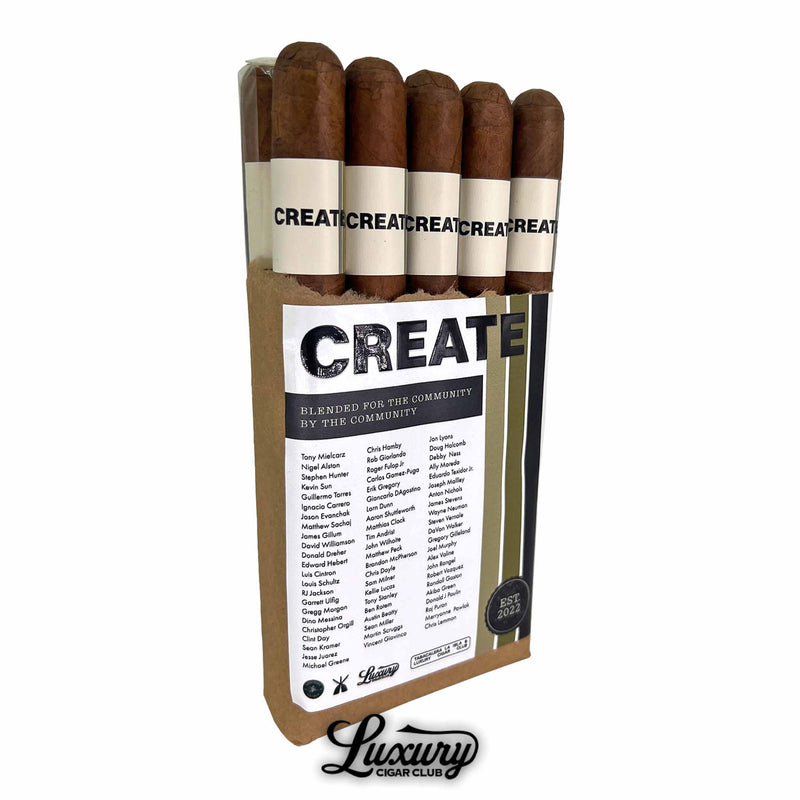 Luxury Cigar Club CREATE Toro cigars partially unwrapped from brown paper packaging, showing the white “CREATE” cigar bands and community name list on the front label.