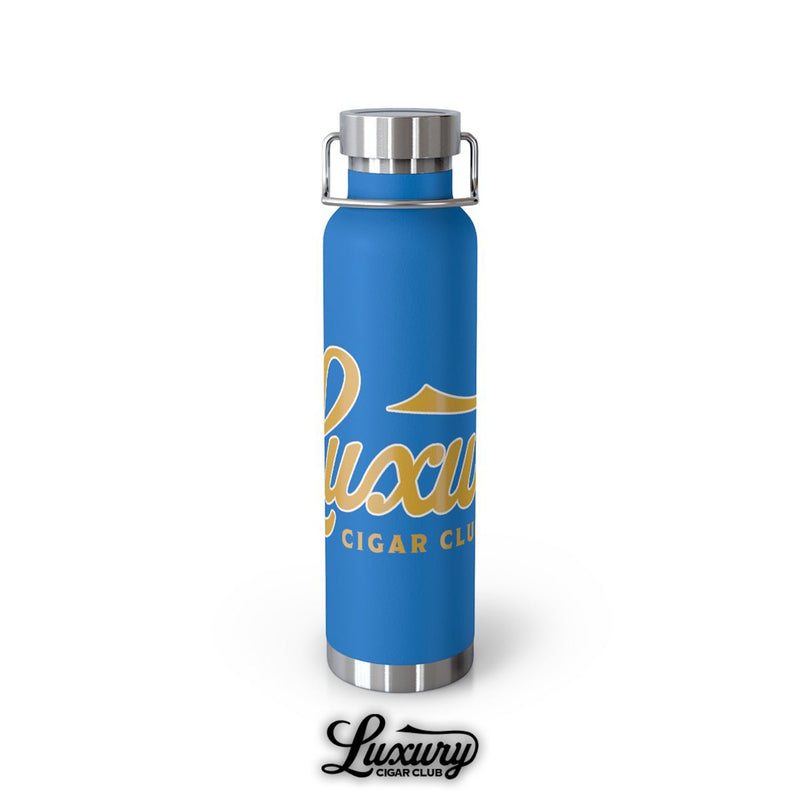 Luxury Cigar Club copper vacuum insulated 22oz bottle in pebble blue with stainless steel lid and bold gold script logo displayed on a clean white background