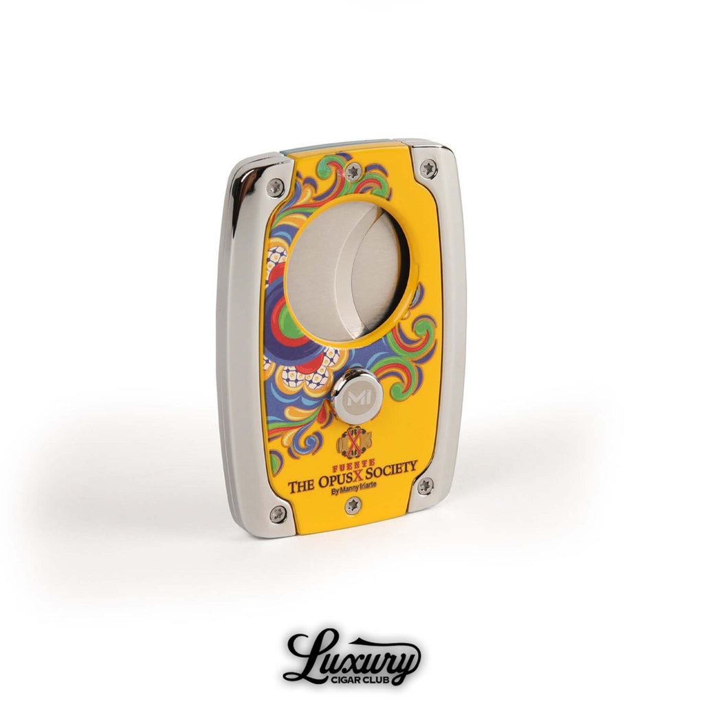 Manny Iriarte Opus X Society Colonial Tiles Cutter featuring a bright yellow enamel finish with colorful tile-inspired design, displayed by Luxury Cigar Club.