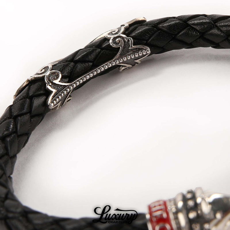 Detailed view of Manny Iriarte Opus X Society black woven leather bracelet with ornate silver Opus X design, cigar accessory at Luxury Cigar Club.