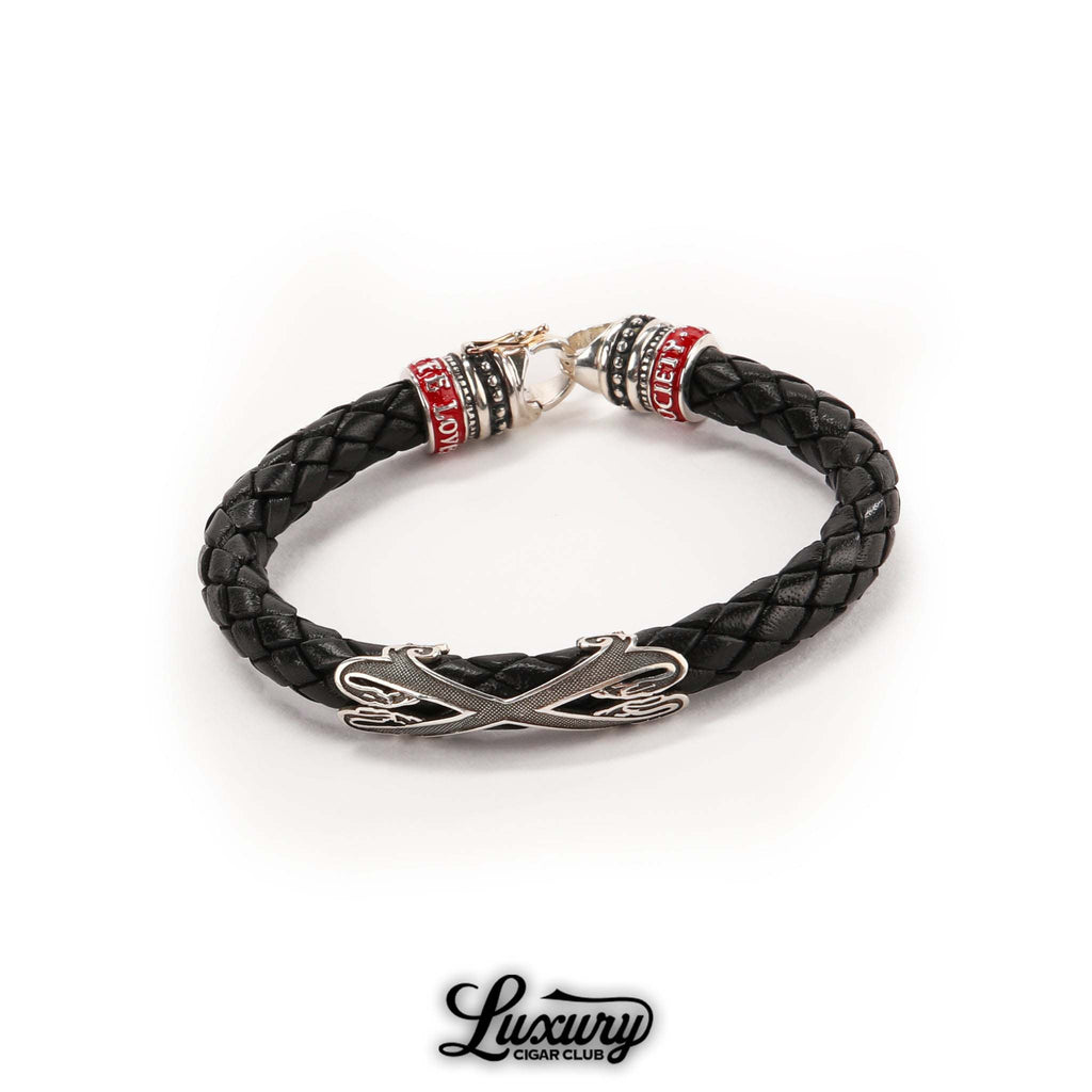 Full view of Manny Iriarte Opus X Society black leather bracelet with silver Opus X emblem and woven design, cigar accessory at Luxury Cigar Club.