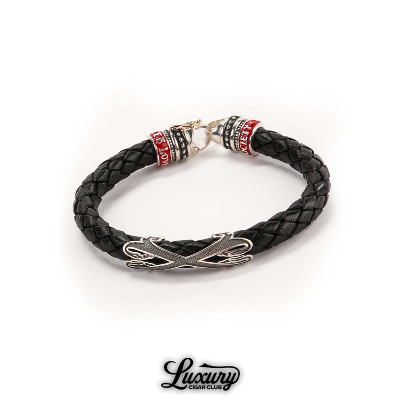 Full view of Manny Iriarte Opus X Society black leather bracelet with silver Opus X emblem and woven design, cigar accessory at Luxury Cigar Club.