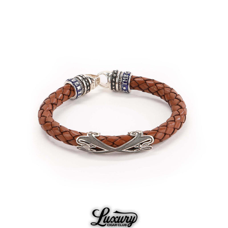 Full view of Manny Iriarte Opus X Society camel woven leather bracelet with silver Opus X emblem, cigar accessory at Luxury Cigar Club.