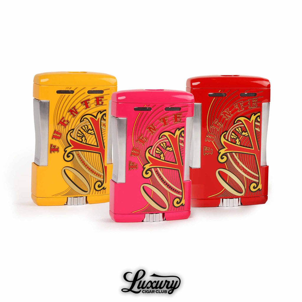Manny Iriarte Opus X Society XOS Table Top Lighters in yellow pink and red finishes displayed together at Luxury Cigar Club