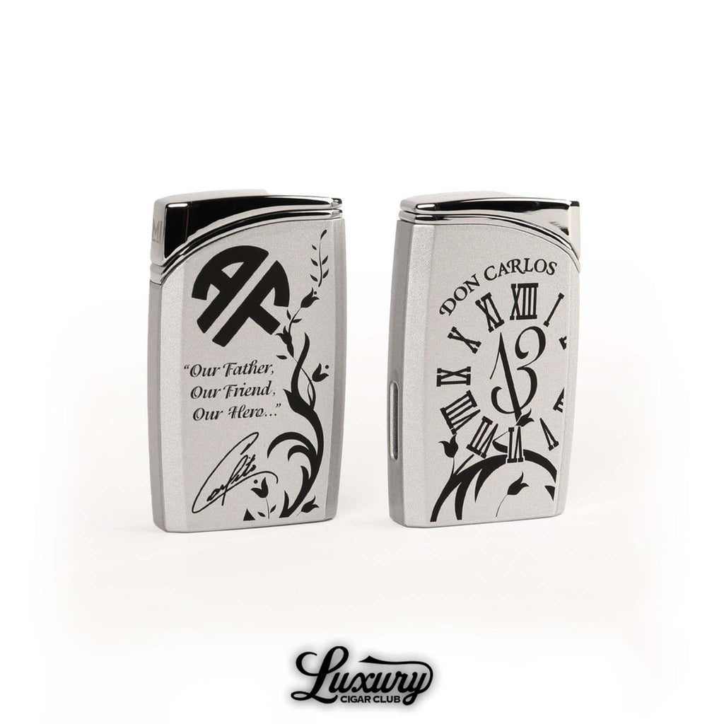 Manny Iriarte Opus X Society OXS Don Carlos J30 lighter in silver with black engraved Roman numerals and quote design honoring Don Carlos luxury cigar accessory