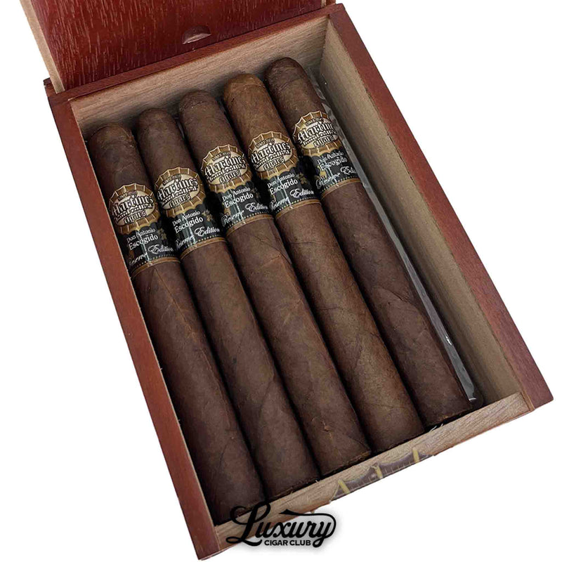 Close-up of five Martinez Don Antonio Escogido MK II Maduro Toro cigars inside the box, showing dark oily maduro wrappers and black and gold cigar bands with the Escogido MK II Edition branding.