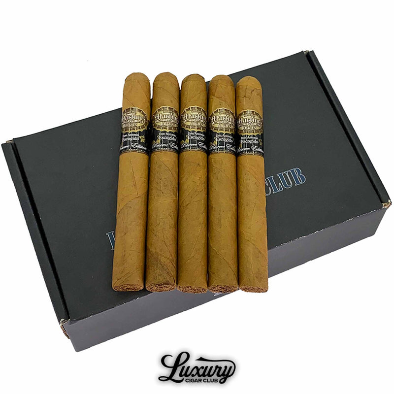 Close-up of five Martinez Don Antonio Escogido Número 5 cigars arranged neatly on a black Luxury Cigar Club box, showcasing golden Connecticut wrappers and elegant black-and-gold cigar bands. Luxury Cigar Club logo beneath.