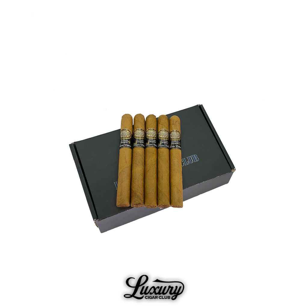 Five Martinez Don Antonio Escogido Número 5 cigars with light brown Connecticut wrappers displayed on top of a sleek black Luxury Cigar Club box. Each cigar features a gold and black band with detailed embossing. Luxury Cigar Club logo below.