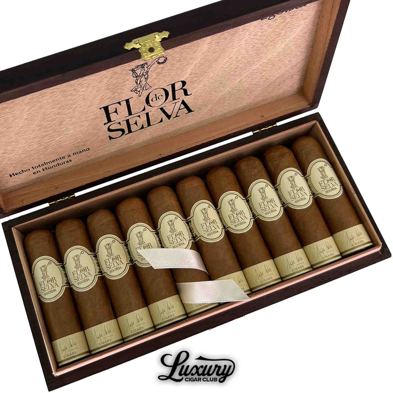 Close-up of Maya Selva Flor de Selva Classic Egoísta cigars arranged neatly in a wooden box with gold clasps and cream cigar bands featuring elegant branding. Luxury Cigar Club logo beneath.