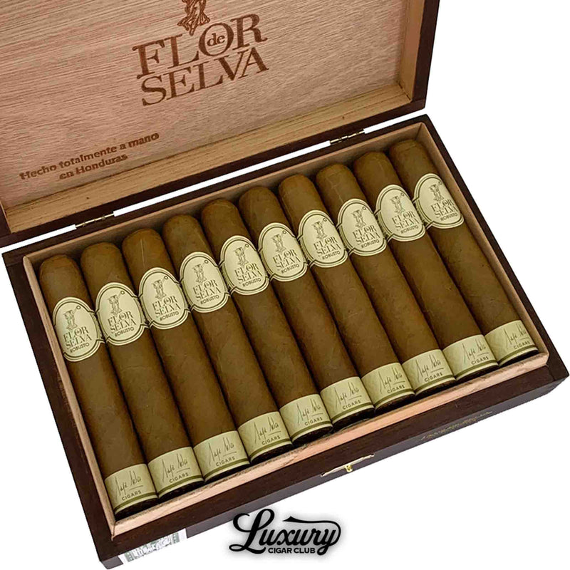 Close-up of Maya Selva Flor de Selva Classic Robusto cigars, highlighting the smooth Connecticut wrappers and refined cream bands inside a wooden box. Luxury Cigar Club logo beneath.