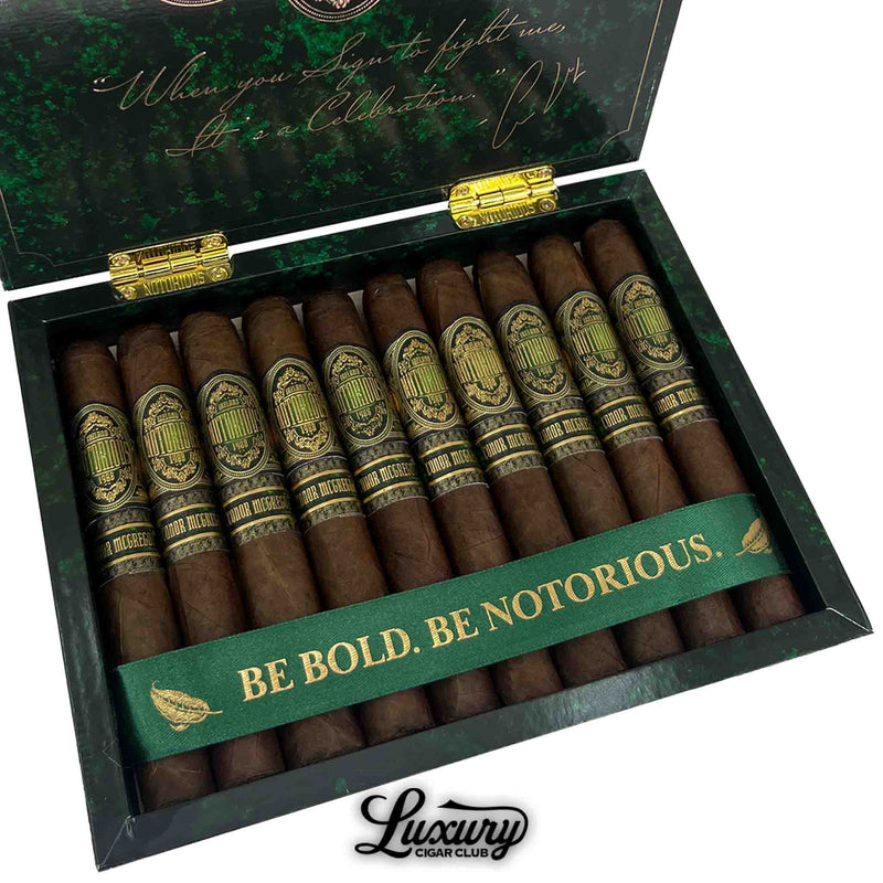 Close-up image of Notorious Conor McGregor Corona Gordo cigars inside a green and gold box with “Be Bold. Be Notorious.” ribbon.