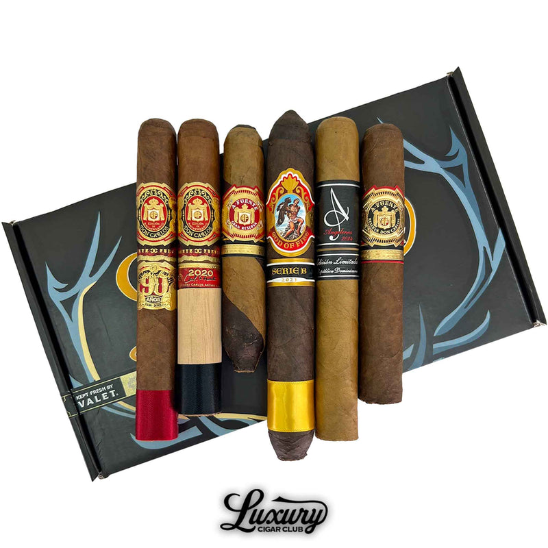 Close up of the Luxury Cigar Club Opus and Prometheus Prestige Sampler displaying six detailed cigar bands from Arturo Fuente OpusX and God of Fire limited editions laid across a Prometheus box for a premium collector focused presentation.