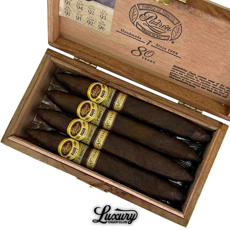 Close-up view of Padron 1926 Serie 80 Years Maduro Perfecto cigars inside a wooden box, featuring cigar ratings and the Luxury Cigar Club logo.