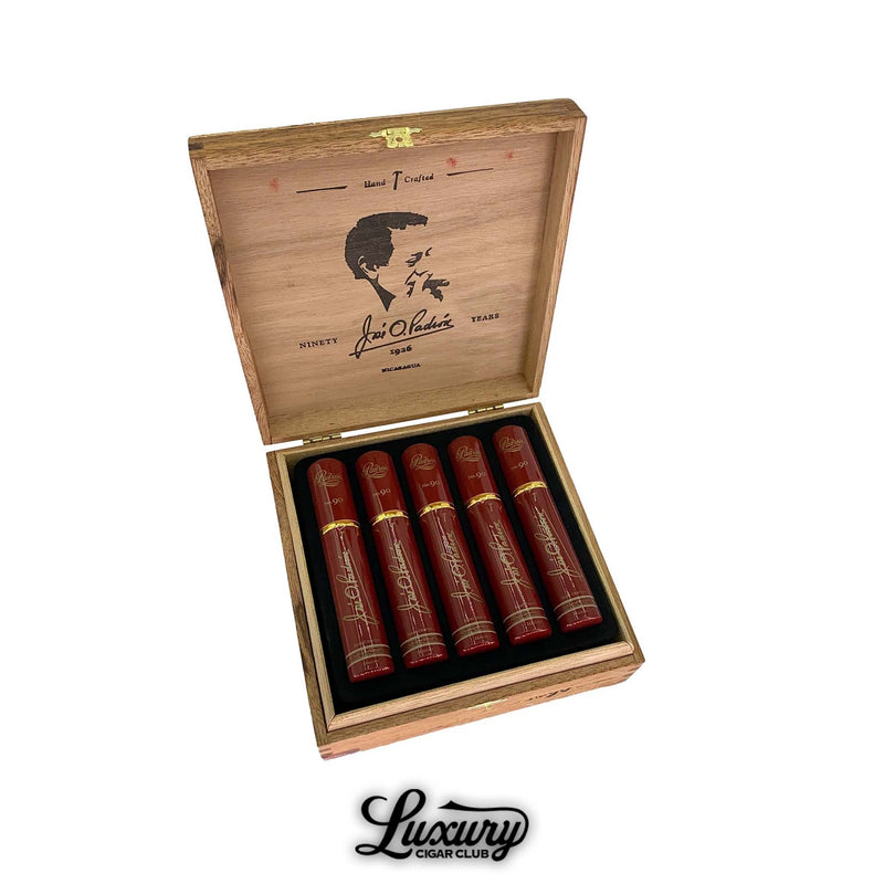 Open box of Padron 1926 Serie No. 90 Maduro cigars, featuring five red tubos with gold accents arranged neatly in a black velvet-lined wooden box with José O. Padrón’s silhouette engraved inside the lid.