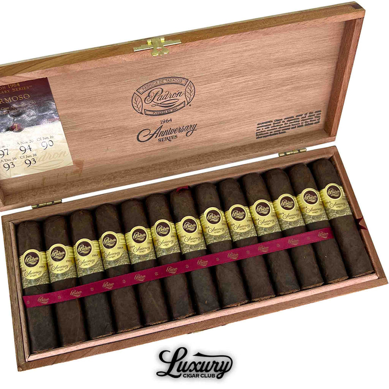 Close-up of Padron 1964 Anniversary Series Maduro Hermoso box, highlighting dark Maduro cigars with gold embossed labels and red ribbon detail. The inner lid shows brand insignia and rating details. Luxury Cigar Club logo below.
