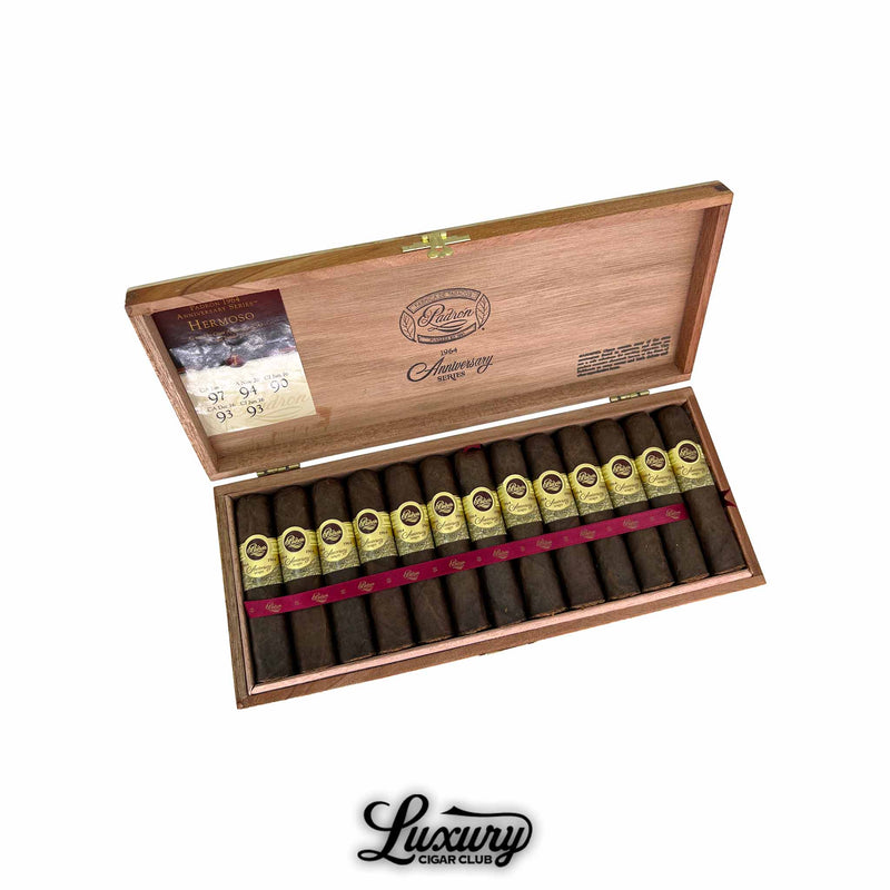 Open wooden box of Padron 1964 Anniversary Series Maduro Hermoso cigars, neatly arranged with golden cream bands and a red ribbon. The lid features the Padron logo and high rating notes. Luxury Cigar Club branding below.