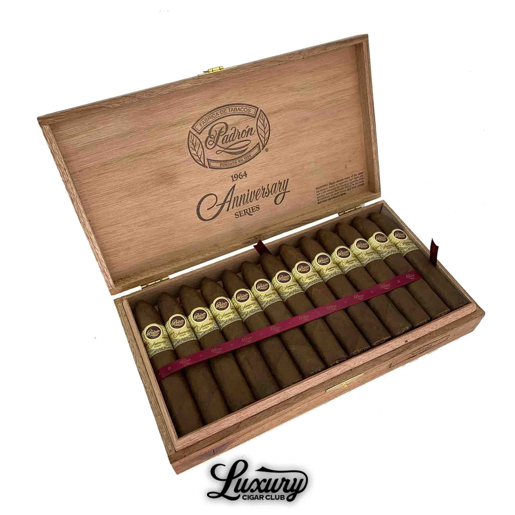 Open box of Padron 1964 Anniversary Series Natural Belicoso cigars, showcasing a full row of tapered cigars with gold and brown bands, set in a wooden box with branded interior lid and Luxury Cigar Club logo.