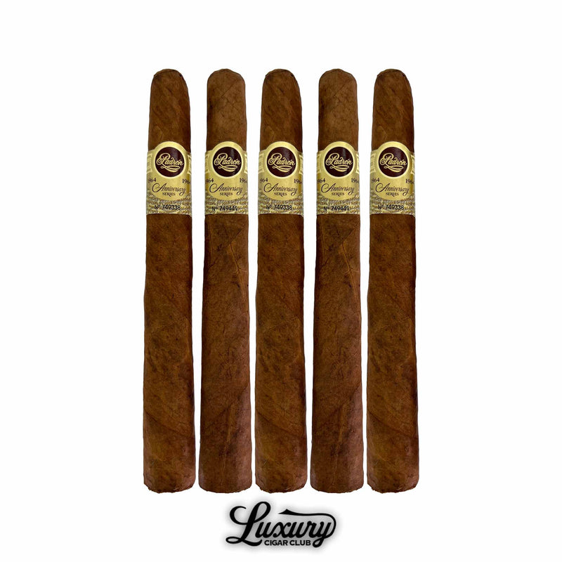Five Padron 1964 Anniversary Series Natural Pyramide cigars showcasing their tapered pyramid heads, natural wrapper leaf, and anniversary bands, photographed for Luxury Cigar Club.