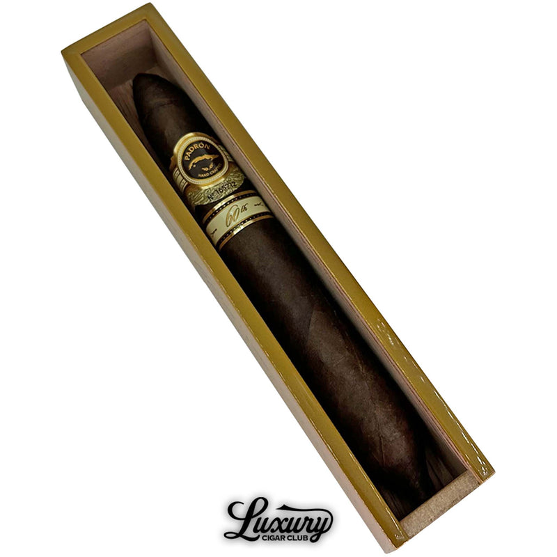 Close-up of the Padrón 60th Anniversary Maduro Double Perfecto cigar in its display box, emphasizing the rich Maduro leaf, gold accents, and masterful craftsmanship, presented by Luxury Cigar Club.