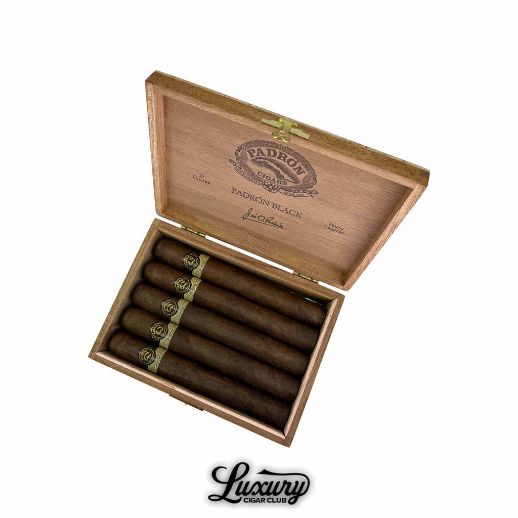Open wooden box of Padron Black Maduro Unicorn PB99 cigars arranged neatly with bold black and gold bands, Luxury Cigar Club logo underneath.