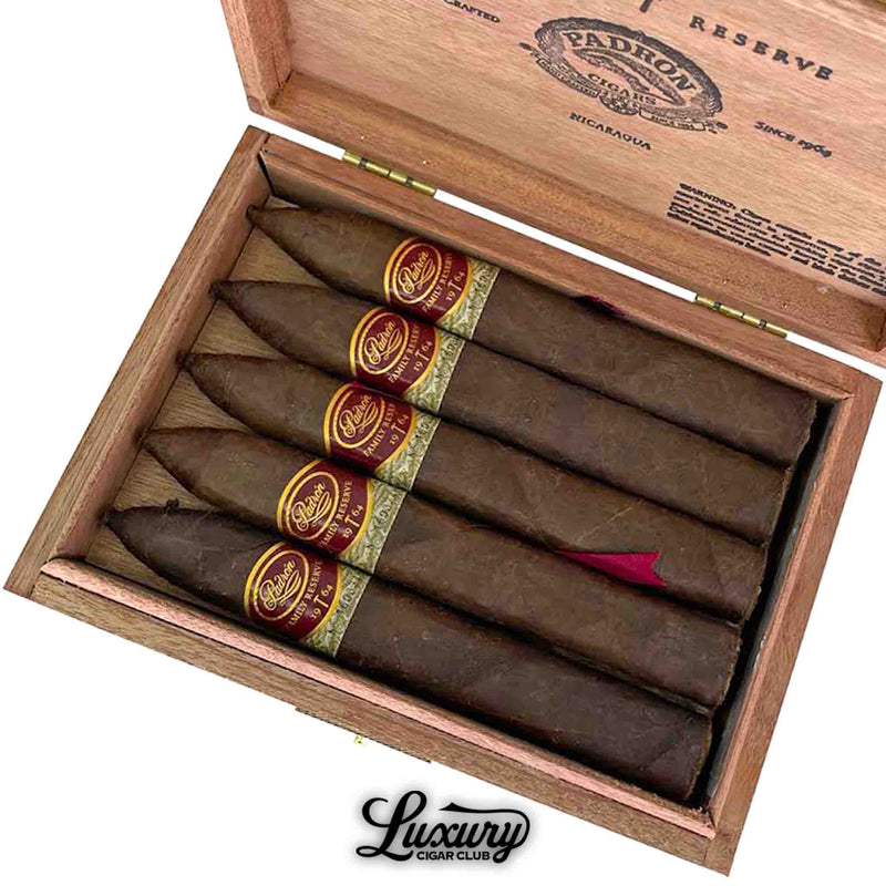 Close-up view of Padrón Family Reserve No. 44 Maduro cigars in box, highlighting rich dark wrapper and decorative cigar bands.