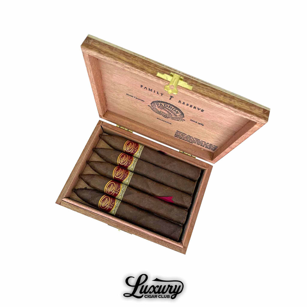 Open box of Padrón Family Reserve No. 44 Maduro cigars arranged neatly inside, showcasing red and gold cigar bands, photographed for Luxury Cigar Club.