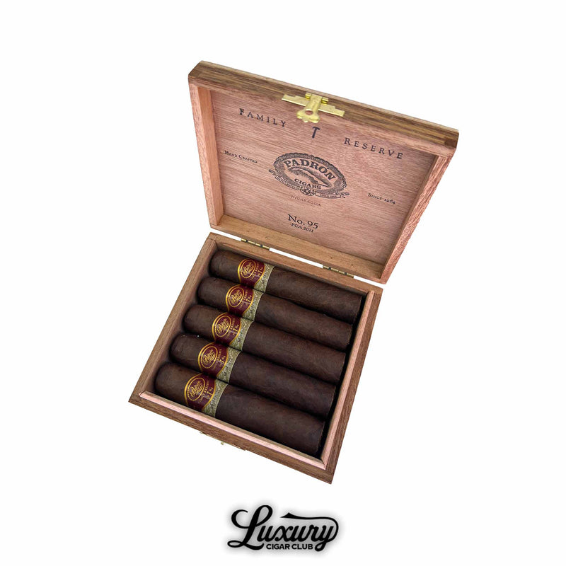 Padrón Family Reserve No. 95 Maduro cigars displayed in open cedar box with gold embossed branding inside lid, Luxury Cigar Club photography.