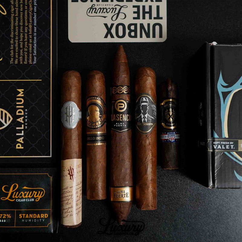 Luxury Cigar Club Palladium subscription box featuring five premium cigars from brands like Plasencia, Sinistro, and United, displayed with a 72% humidity pack and elegant packaging.