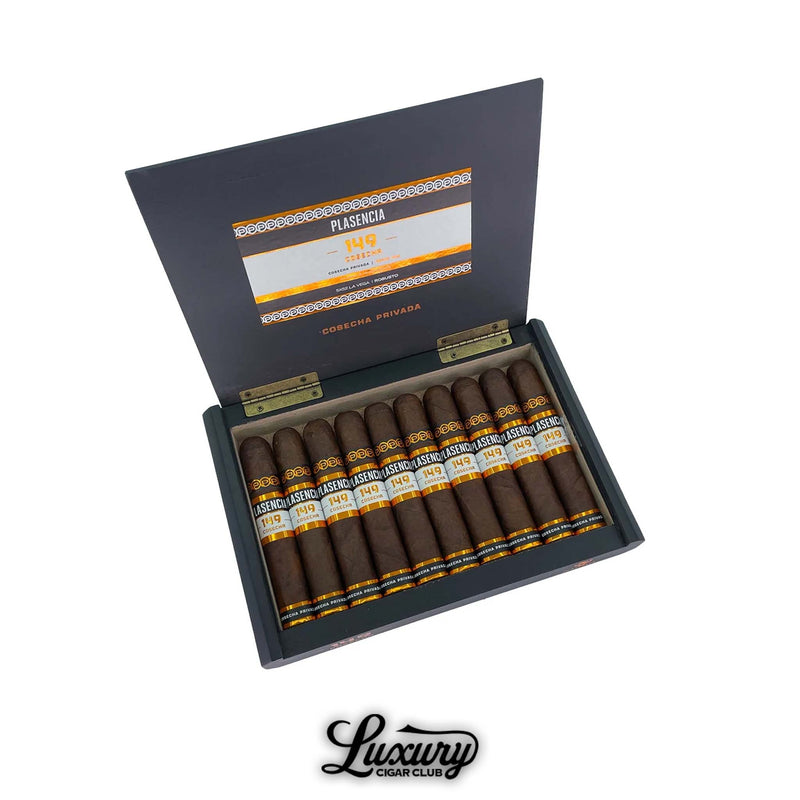 Open box of Plasencia Cosecha 149 La Vega cigars containing 10 dark brown cigars with black, white, and orange bands, displayed in a sleek black box with “Cosecha Privada” printed on the inside lid, along with the Luxury Cigar Club logo at the bottom.