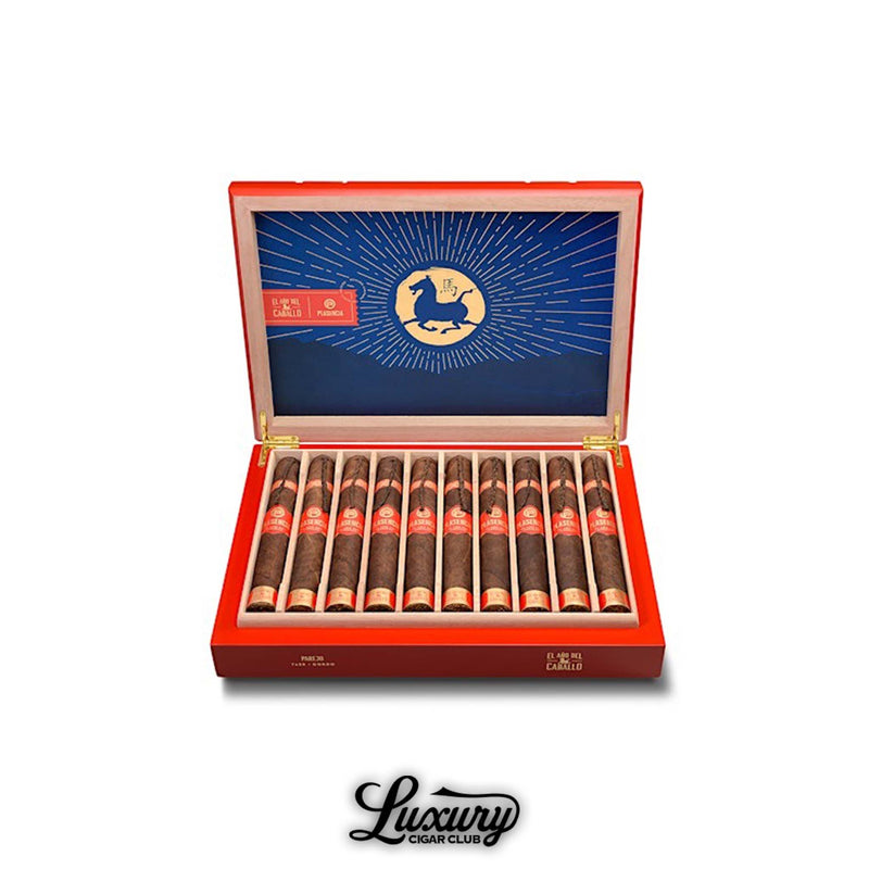 Open red box of Plasencia El Año del Caballo Parejo Gordo cigars, showcasing twelve dark, oily cigars with red and gold bands. The interior lid features a striking blue and gold design with a horse emblem radiating golden rays, symbolizing the Year of the Horse. The cigars are precisely arranged, highlighting Plasencia’s luxurious craftsmanship. Displayed above the Luxury Cigar Club logo. Luxury Cigar Club.