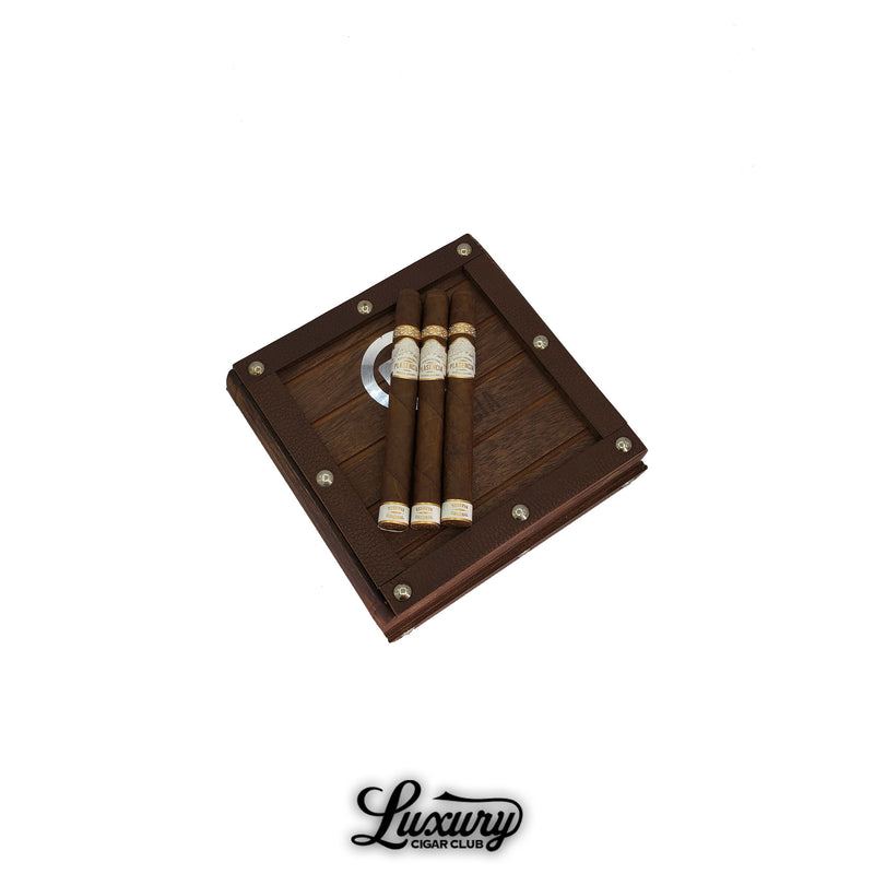 Plasencia Reserva Original Corona cigars displayed on a rustic wooden box with metal rivet accents, showcasing organic premium Nicaraguan tobacco at Luxury Cigar Club.