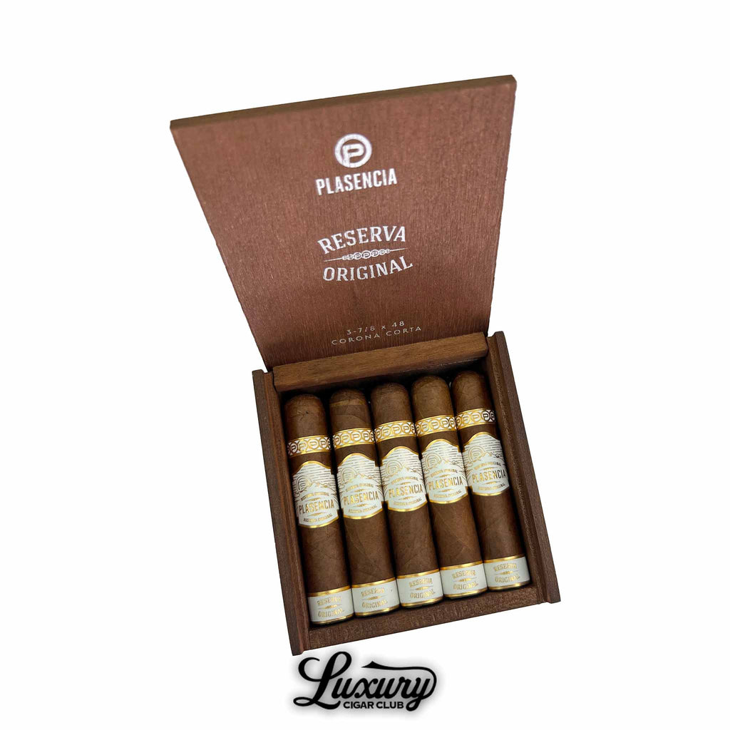 Plasencia Reserva Original Corona Corta cigars neatly displayed in an open wooden box with elegant white and gold detailing, presented by Luxury Cigar Club.