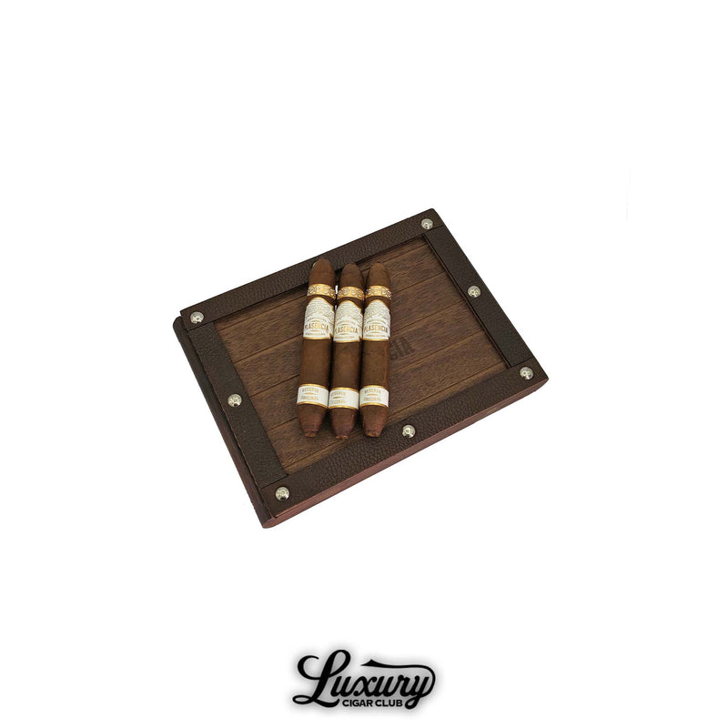 Plasencia Reserva Original Cortez cigars displayed on a rustic wooden box with metal accents, showcasing organic Nicaraguan craftsmanship — available at Luxury Cigar Club.