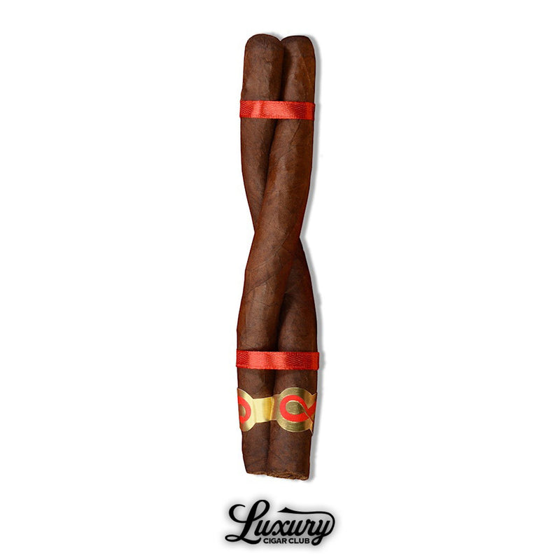 Close-up of the Plasencia Year Of The Snake Unicorn Culebra cigar, featuring two twisted cigars bound with red ribbon and gold infinity band, available at Luxury Cigar Club.