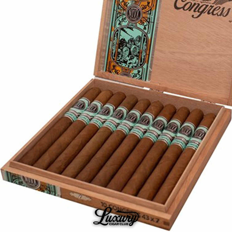 Close-up of Platinum Nova Congress Lonsdale cigars inside an open box, showing smooth brown wrappers, teal and silver decorative bands, and detailed interior box art. Luxury Cigar Club logo beneath.