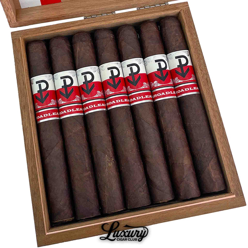 Close up of Powstanie Broadleaf Toro cigars in box highlighting dark broadleaf leaf texture and Powstanie branding by Luxury Cigar Club