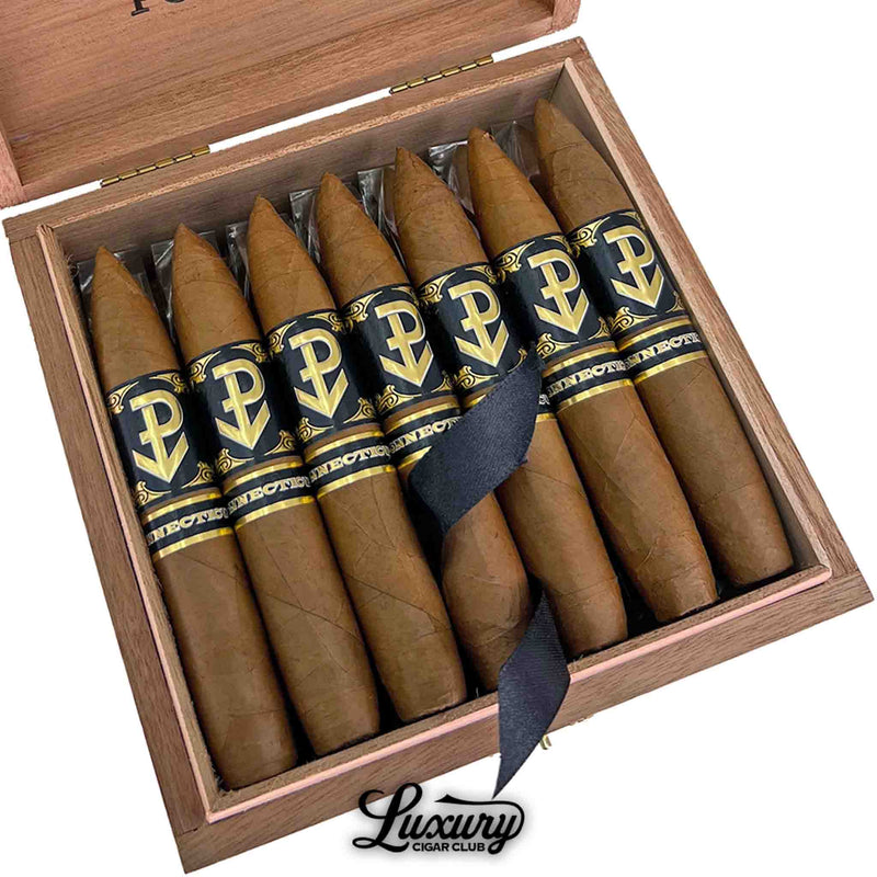 Close-up of Powstanie Connecticut Perfecto cigars highlighting silky golden Connecticut wrappers and sleek black-and-gold bands inside a cedar-lined box from Luxury Cigar Club.