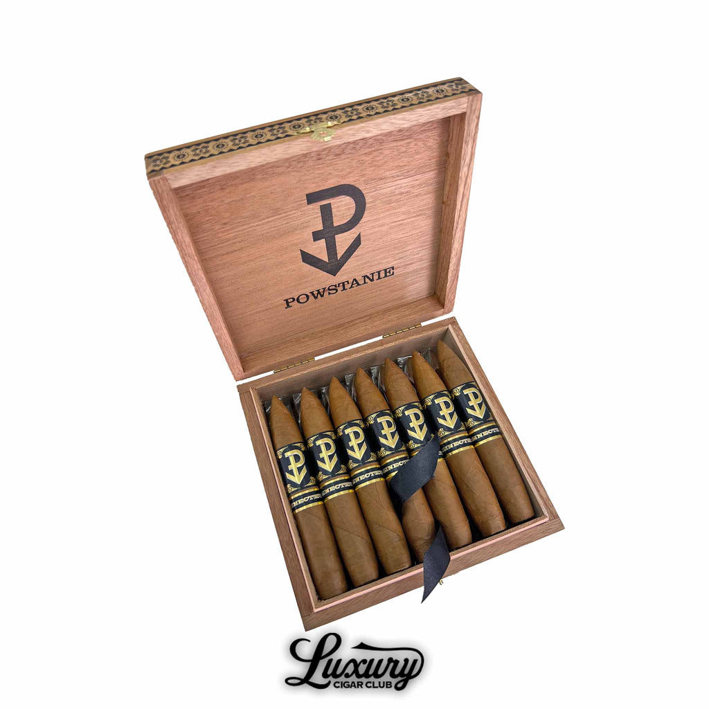 Powstanie Connecticut Perfecto cigars presented in an open wooden box with bold black and gold branding, featuring torpedo-shaped cigars and the signature Luxury Cigar Club mark.