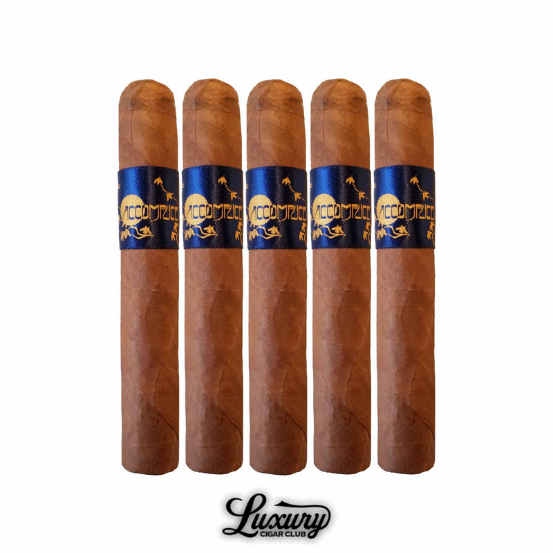 Set of five Principle Accomplice Connecticut cigars standing upright, each wrapped in a smooth golden-brown Ecuadorian Connecticut wrapper. The cigars feature deep blue and gold bands with the Accomplice logo and lizard design, symbolizing refined craftsmanship and elegance. Displayed on a white background above the Luxury Cigar Club logo. Luxury Cigar Club.