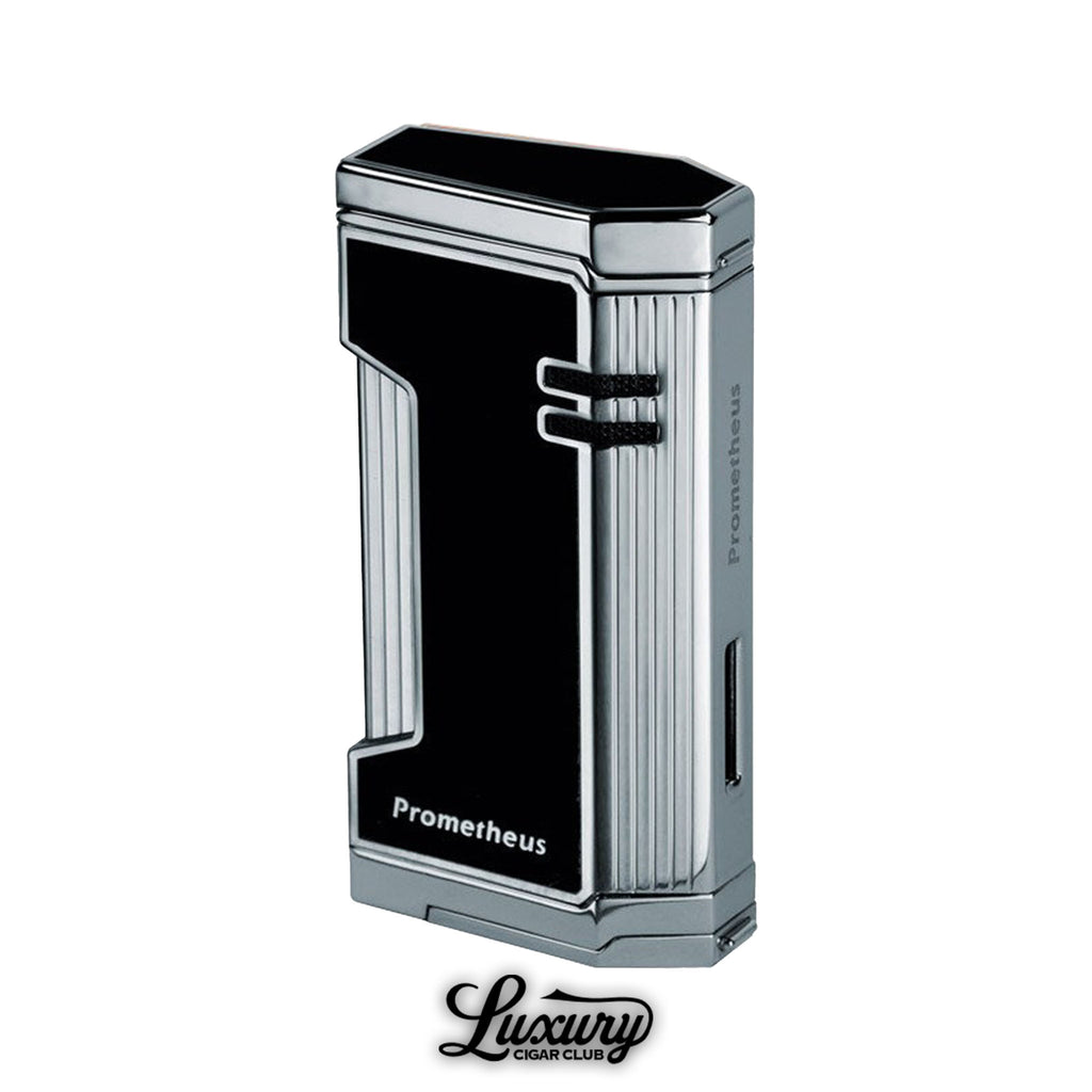 Prometheus Magma X Torch Lighter in black lacquer and chrome finish, featuring a sleek, angular design with triple torch jets and Prometheus branding. Displayed above the Luxury Cigar Club logo.