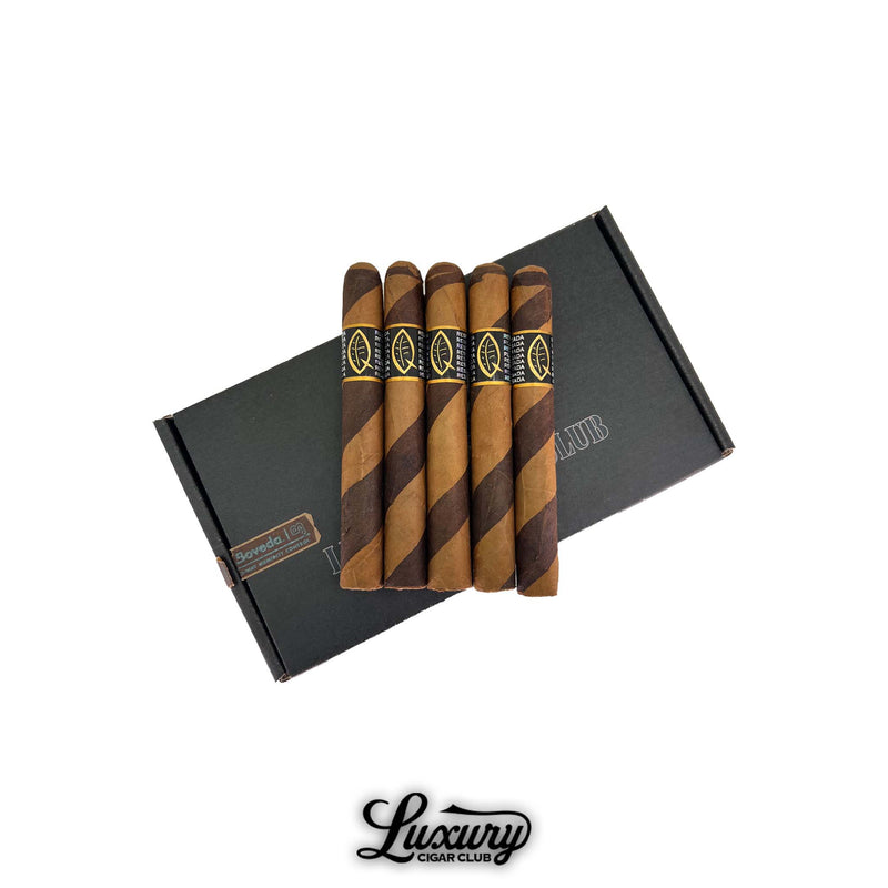 Five Quesada Aged Reserva Privada Corona Gorda cigars with alternating barber pole wrappers displayed on a black Luxury Cigar Club box. Each cigar features a black and gold Quesada band with the leaf logo.