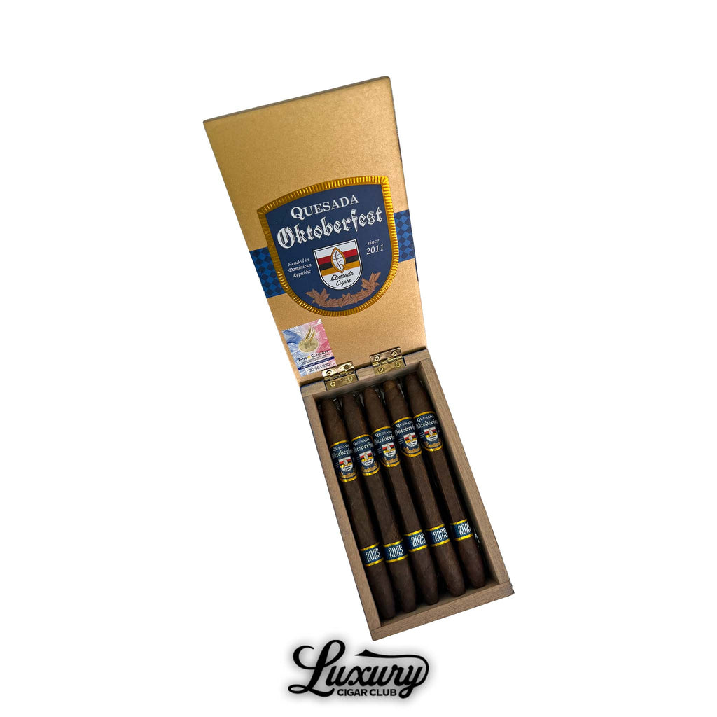 Open box of Quesada Oktoberfest 2025 Salomon cigars with golden lid and blue Oktoberfest branding, available at Luxury Cigar Club.