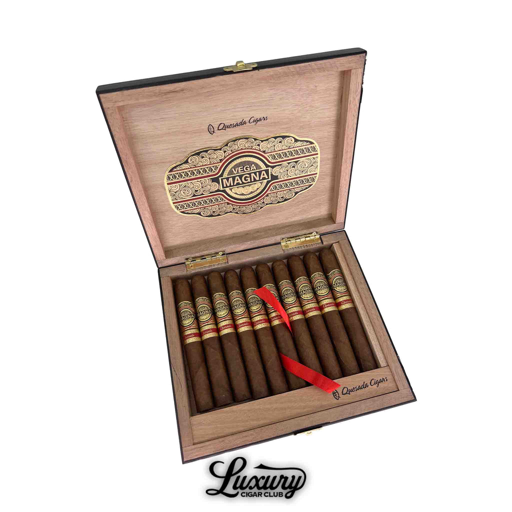 Quesada Vega Magna Limited Production Robusto cigars arranged in an elegant wooden box with gold and red embossed labels, available at Luxury Cigar Club.