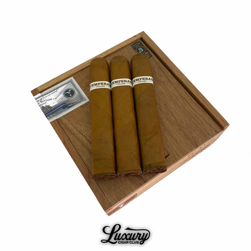 RoMa Craft Intemperance EC XVIII Goodness cigars resting on a cedar box, featuring light Ecuador Connecticut wrappers and clean white bands, presented by Luxury Cigar Club.