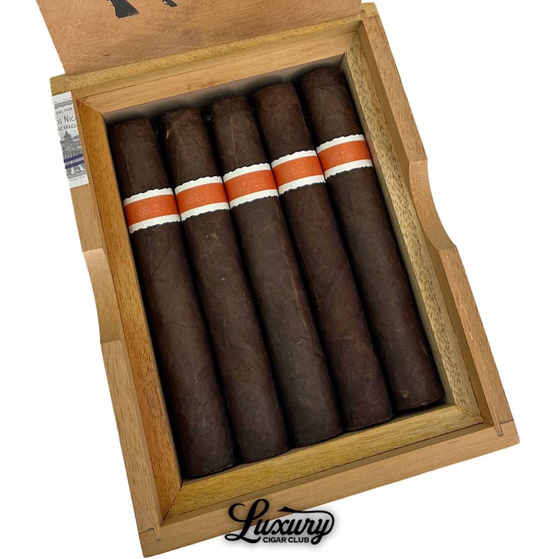 Close up of RoMa Craft Neanderthal JCF cigars highlighting rugged dark wrappers and signature orange bands from Luxury Cigar Club