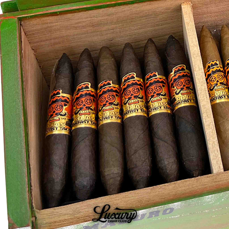 Close-up of Rojas Breakfast Tacos Maduro Petite Salomon cigars emphasizing the rich, dark wrapper and vibrant branding, available from Luxury Cigar Club.