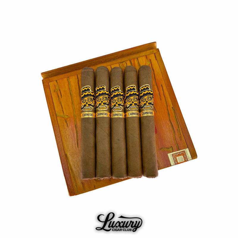 Rojas Street Tacos Carnitas Short Corona cigars resting on a wooden box lid with colorful grain detail, showcasing vibrant yellow and black bands with skull artwork, presented by Luxury Cigar Club.